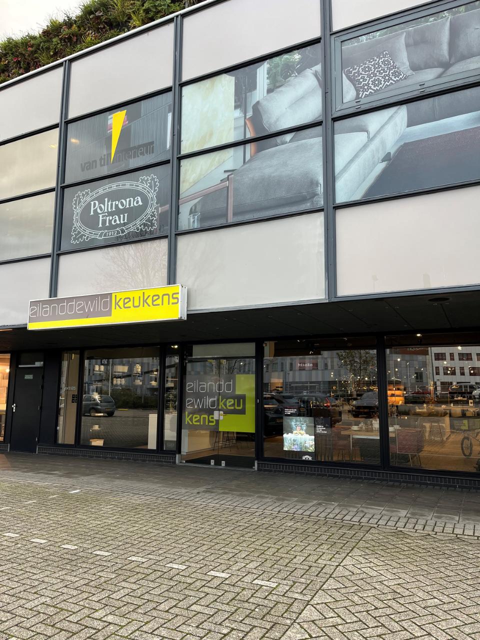 Buitenaanzicht Eiland de Wilde keukens met op de voorgrond parkeerplekken